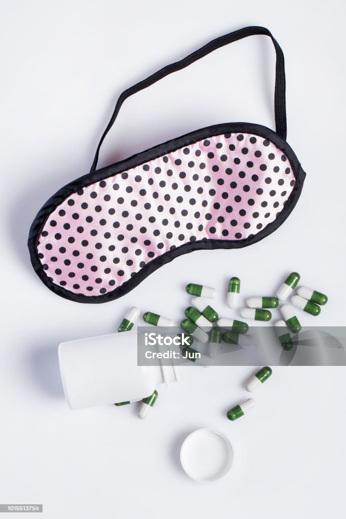 Mask and sleeping pills Mask and sleeping pills on white background Insomnia Stock Photo