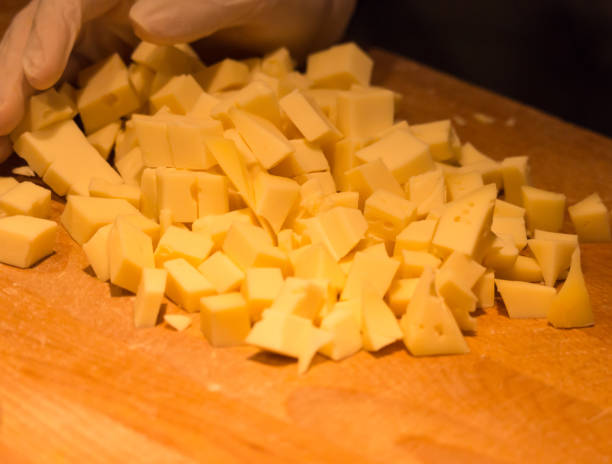 istock Pieces of cheese with a hand 1015516274