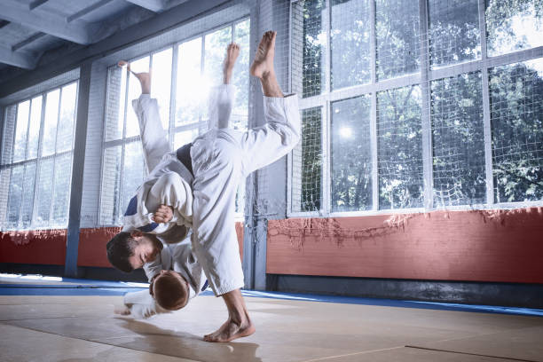 istock Two judo fighters showing technical skill while practicing martial arts in a fight club 1015518500