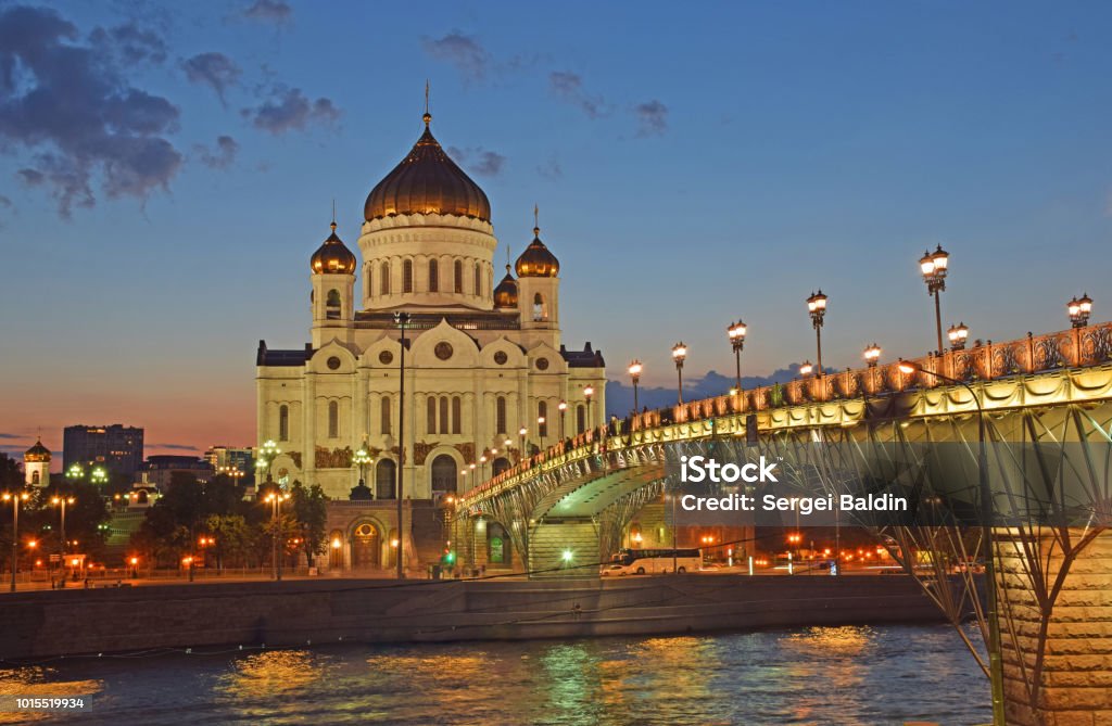 The Cathedral of Christ the Savior and the Patriarch's Bridge in the evening The Cathedral of Christ the Savior was built by the architect Konstantin Ton in 1883. The building of the temple was destroyed in 1931. It was restored in 1997. Moscow, Russia, August 2018. Architectural Dome Stock Photo