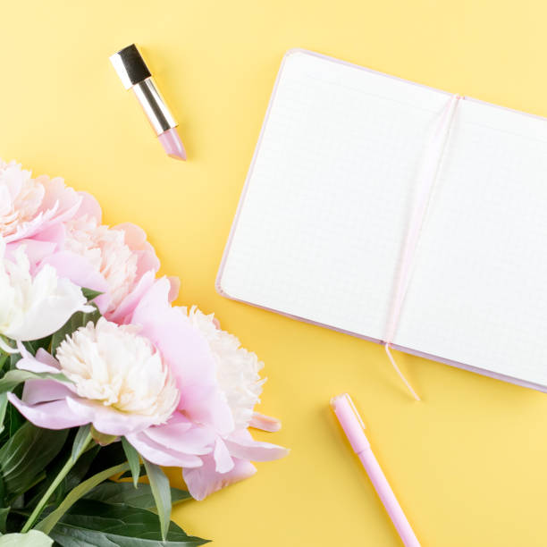 istock Flat lay home office desk. Feminine workspace with open blank note book, peony flowers, eyeglasses. 1015522242