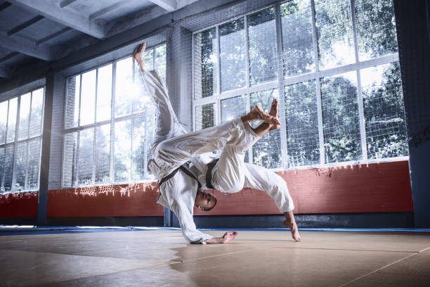 istock Two judo fighters showing technical skill while practicing martial arts in a fight club 1015522574