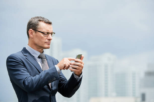 istock Mature entrepreneur with smartphone 1015522716