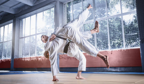 istock Two judo fighters showing technical skill while practicing martial arts in a fight club 1015527010