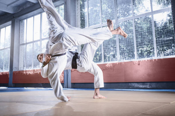istock Two judo fighters showing technical skill while practicing martial arts in a fight club 1015531460