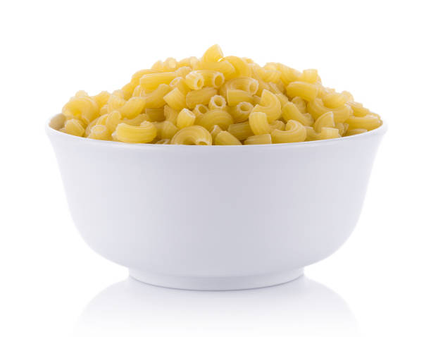 istock macaroni in bowl on white background,italian pasta. top view 1015533720