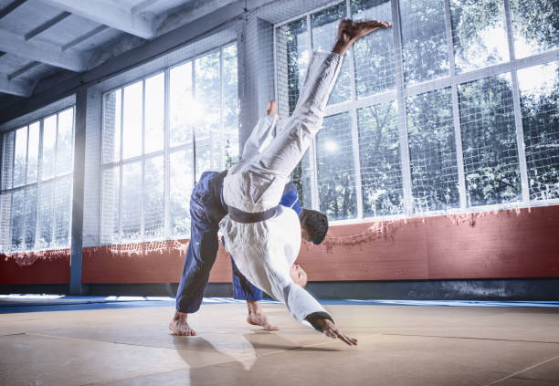 istock Two judo fighters showing technical skill while practicing martial arts in a fight club 1015541192