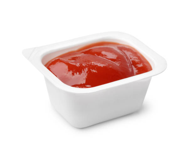 istock Open ketchup fast food dip packet 1015545370