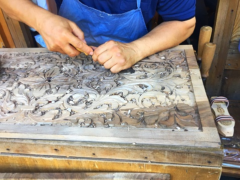 Sultanahmet, Istanbul, Turkey - June 6, 2018: A wood carving worker is working in public place in Ramadan month.