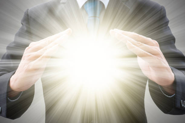 istock Businessman and light burst between his hands 1015561970