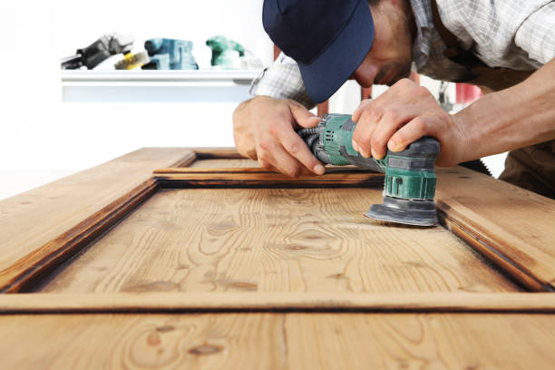 istock carpenter work the wood with the sander 1015564838