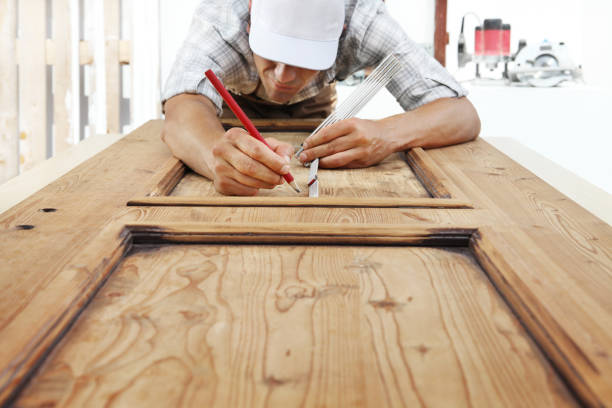 istock carpenter at work measures with the meter and pencil on wood background 1015564874