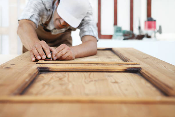 istock carpenter work the wood with the sandpaper 1015564930