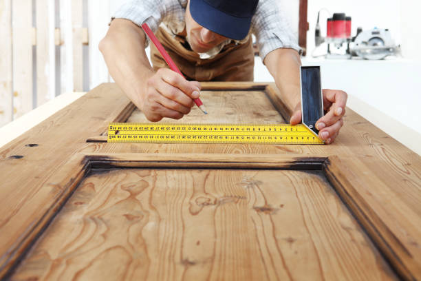 istock carpenter at work measures with the setsquare and pencil on wooden board background 1015564936