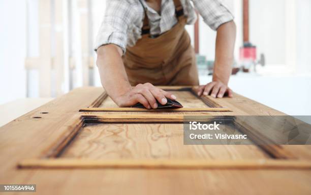 Carpenter Work The Wood With The Sandpaper Stock Photo - Download Image Now - Door, Wood - Material, Carpenter