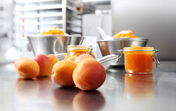 istock Jam from apricots in a glass jar on a polished stainless steel surface in pastry worktop 1015565664