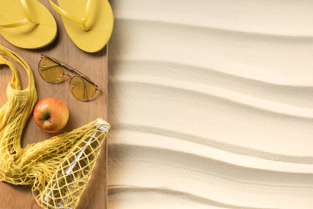 istock flat lay with feminine yellow accessories for rest on beach on sand 1015577246