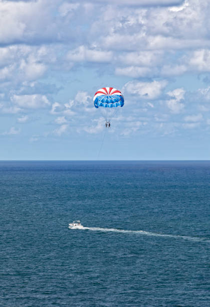 Two people go parasailing on the Atlantic Ocean stock photo