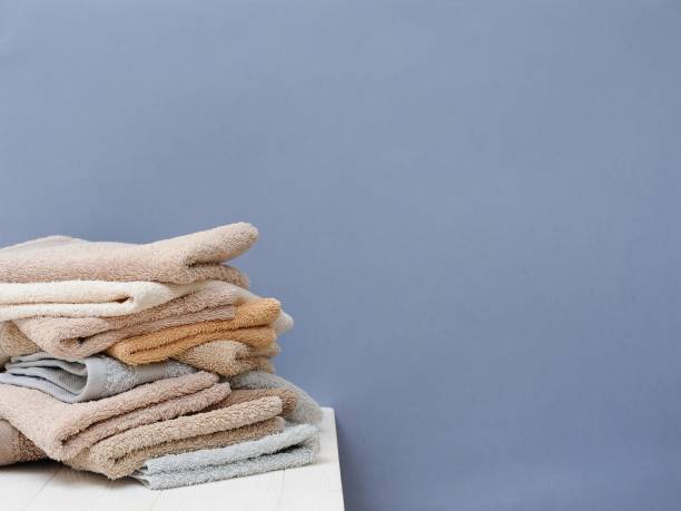 istock A stack of colorful towels on a grey background isolation.Closeup. Scandinavian style 1015585184