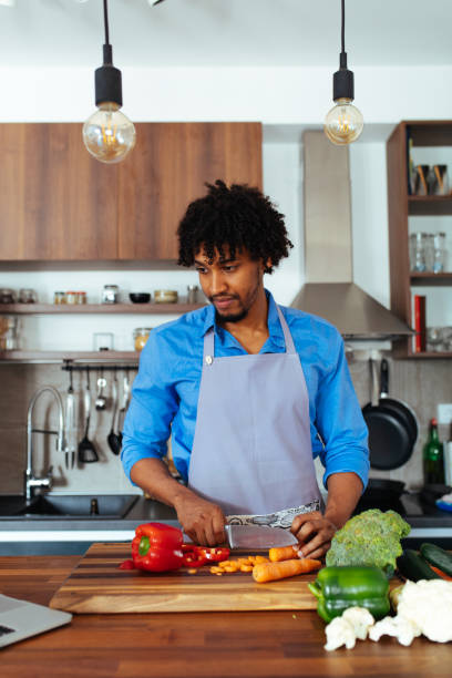 istock I'll cook today. Attractive male preparing a meal 1015589200