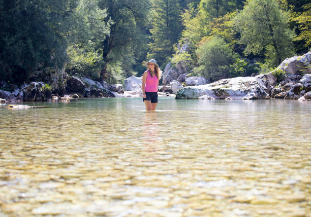 istock Young woman walking in the river Soca 1015589422