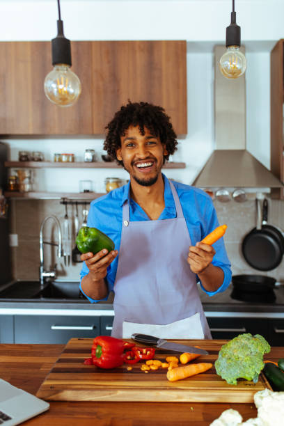 istock I'll cook today. Attractive male preparing a meal 1015589506