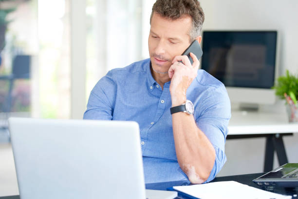 istock Businessman with mobile phone and notebook in the office 1015589802