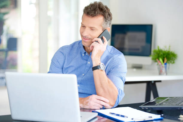istock Businessman with mobile phone and notebook in the office 1015589848