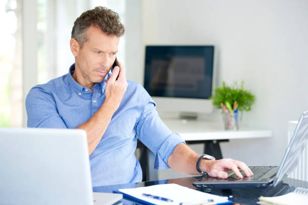 istock Businessman with mobile phone and notebook in the office 1015589850
