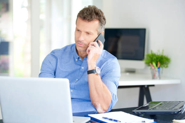 istock Businessman with mobile phone and notebook in the office 1015589862