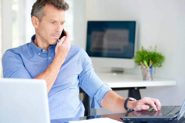 istock Businessman with mobile phone and notebook in the office 1015589880