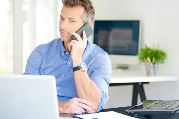 istock Businessman with mobile phone and notebook in the office 1015589906
