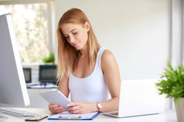 istock Sales woman holding touchpad in her hand 1015598094