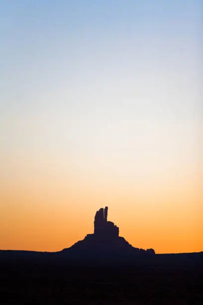 Monument Valley butte silhouetted at sunset, Utah, USA