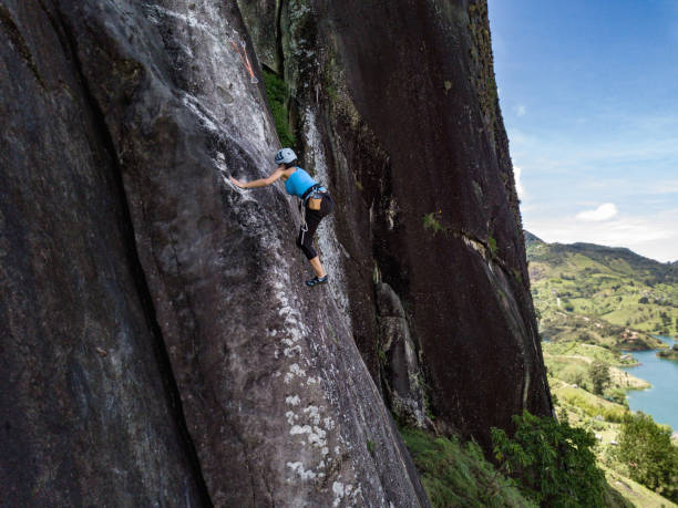 istock Adventurous woman climbing a rock at Guatape 1015604022