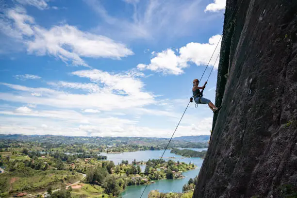 Photo of Happy woman rock climbing at Guatape