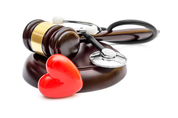 gavel with red heart and stethoscope on white. medical law. - patient stethoscope gavel hammer imagens e fotografias de stock