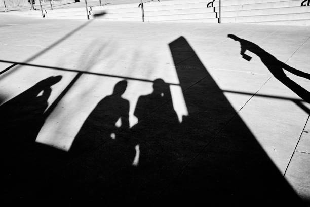 istock People silhouettes on a pavement. 1015612578