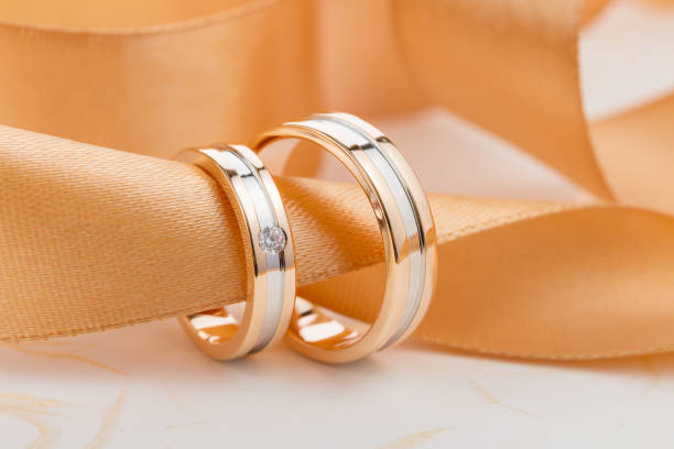 istock Two-tone wedding rings with ribbon 1015612582