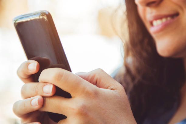 istock Woman using phone outside 1015623750
