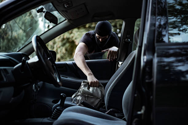 вор краже сумочку из автомобиля - car stealing thief car thief стоковые фото и изображения