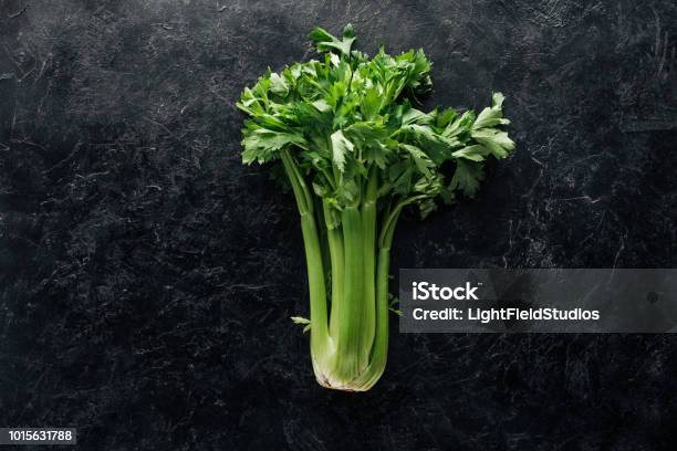 Top View Of Fresh Green Celery On Black Marble Surface Stock Photo - Download Image Now