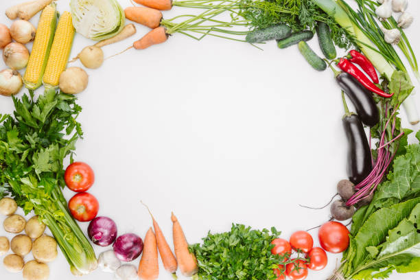 istock flat lay with fresh autumn vegetables arranged with blank space in middle isolated on white 1015631994