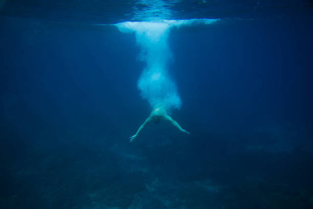 istock partial view of man diving into ocean 1015632466