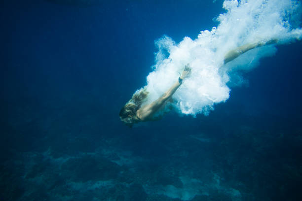 istock underwater pic of young man diving in ocean alone 1015632482