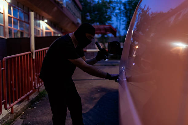 istock Car Burglar Stealing the Vehicle 1015634800
