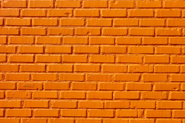 close up orange ziegelmauer - faded close up horizontal outdoors stock-fotos und bilder