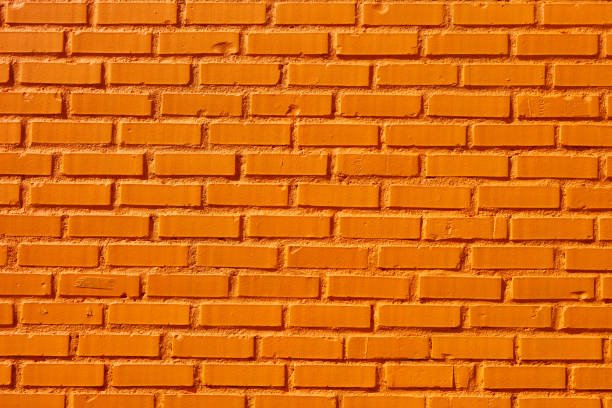 cerca de pared de ladrillo naranja - orange wall fotografías e imágenes de stock