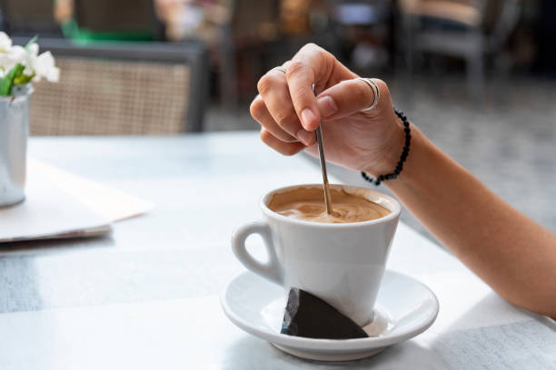 istock Young woman stirring a coffee 1015638478