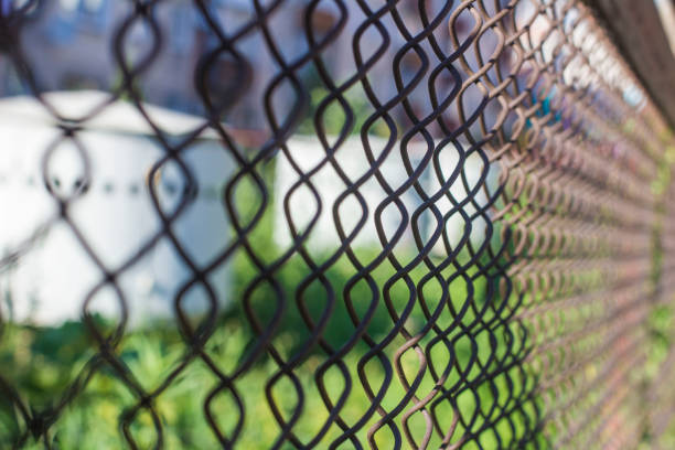istock gas storage behind barbed wire on blurred bokeh background 1015638638